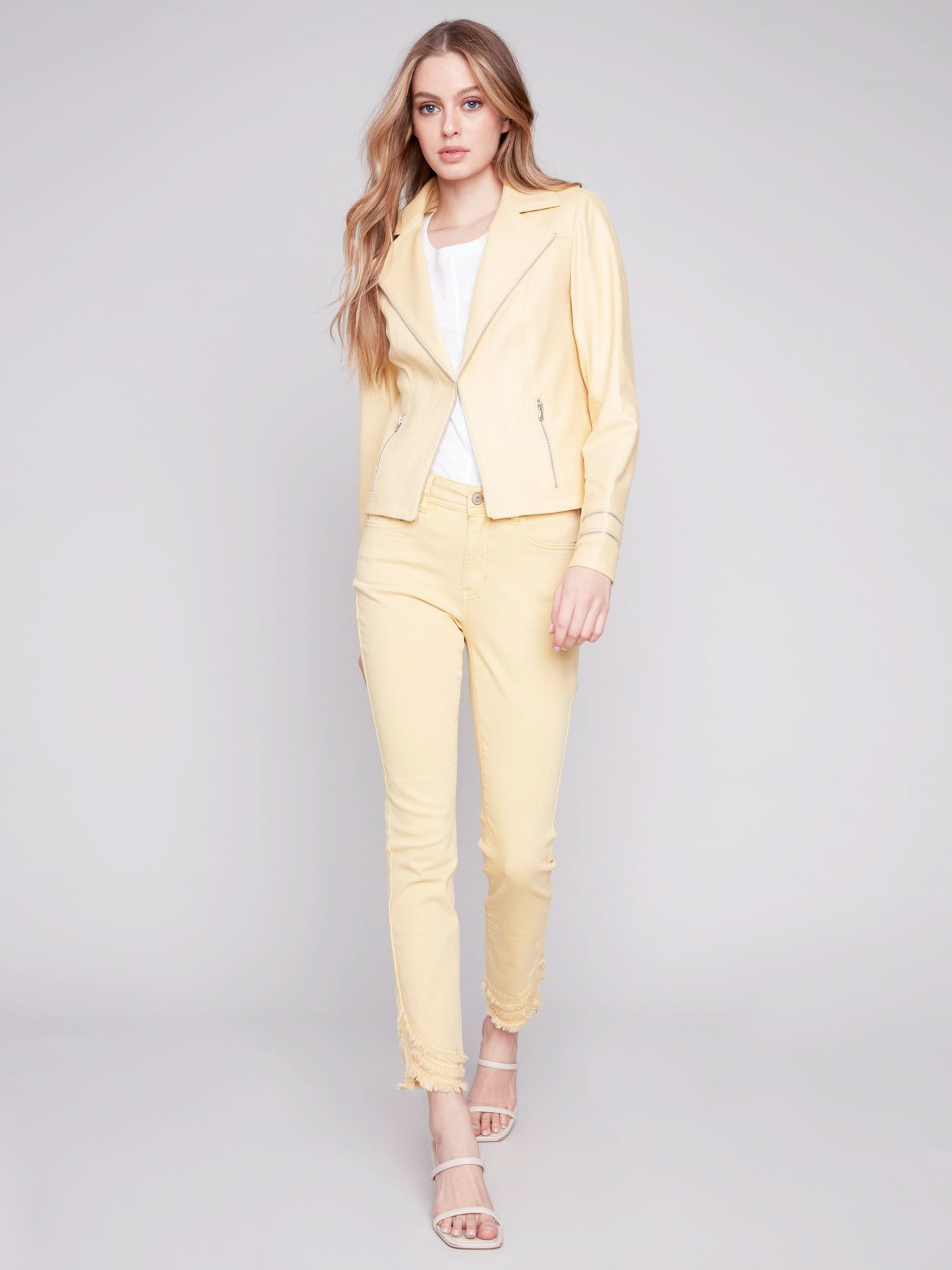 A woman wearing a yellow Charlie B Vintage Moto Faux Leather Jacket.