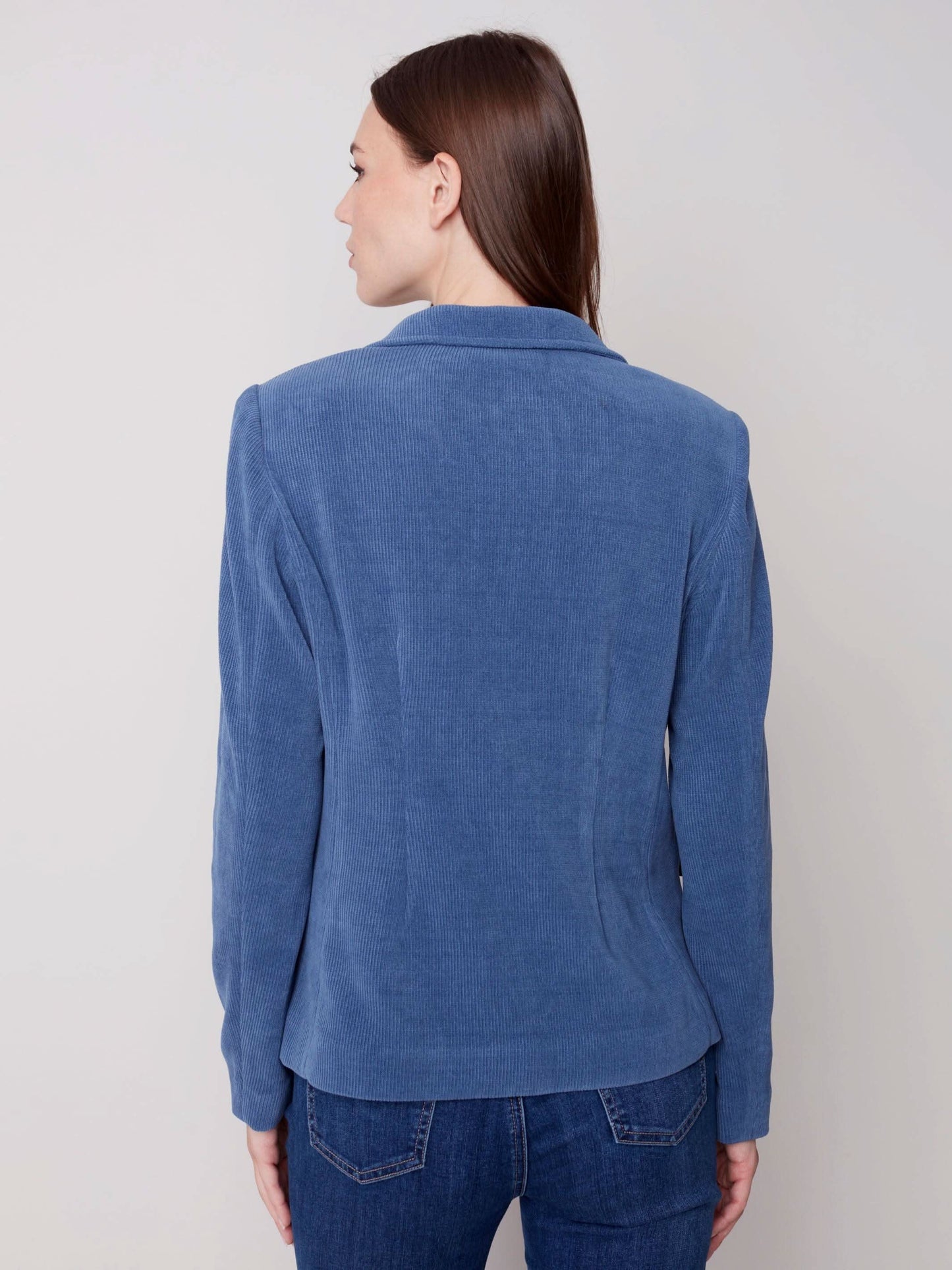 The model is wearing jeans and a Charlie B Buttoned-front Corduroy Blazer.