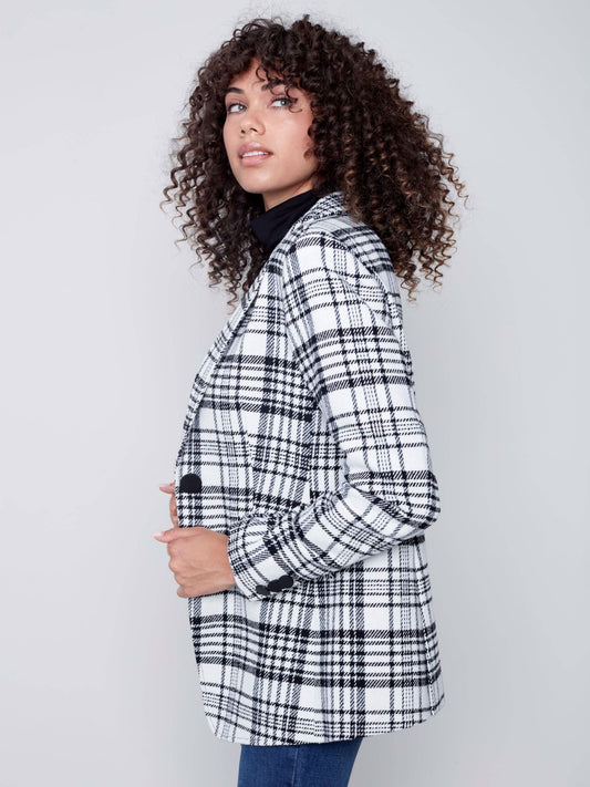 A woman wearing a Charlie B Plaid Long Blazer, perfect for formal occasions.