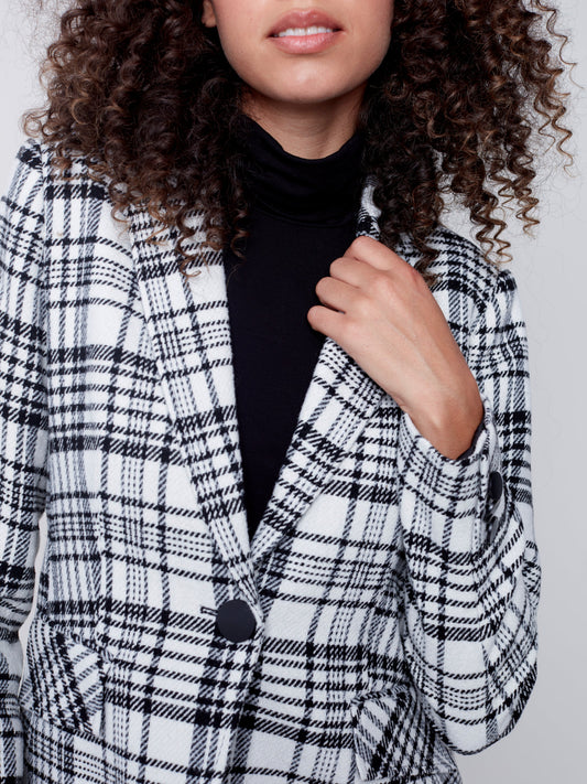 A woman wearing a Charlie B Plaid Long Blazer, perfect for formal occasions.