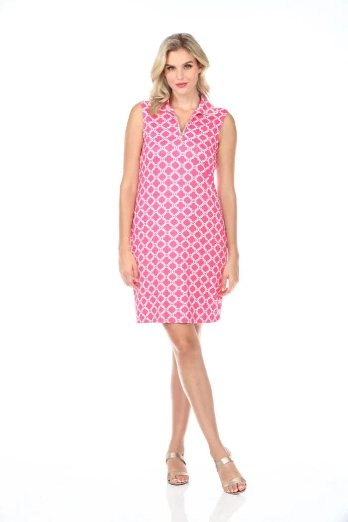A woman in a Tango Mango 1/4 Zip Sleeveless Dress with a pink and white pattern stands against a pristine white background.