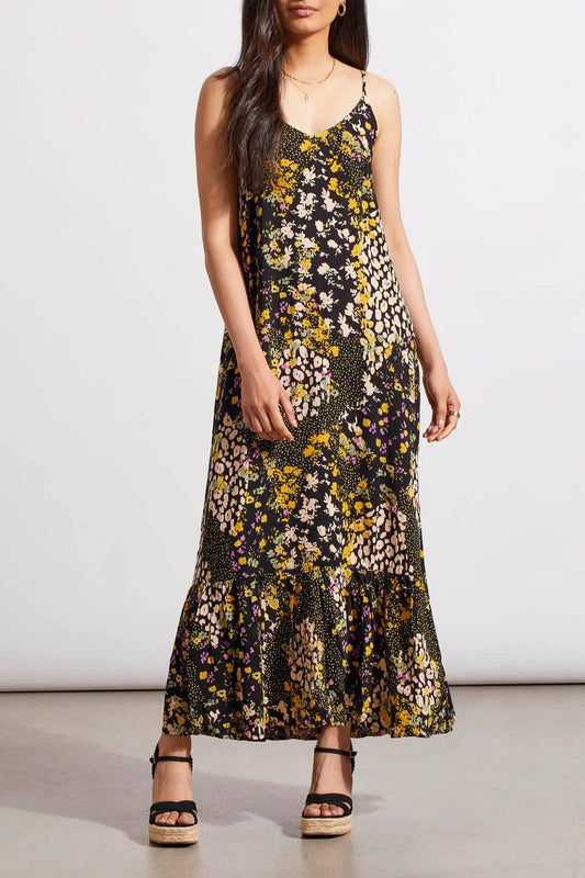 Woman modeling a Ditsy Floral Print Maxi Dress from Tribal with a flounce hem and strappy sandals, crafted from lightweight material.