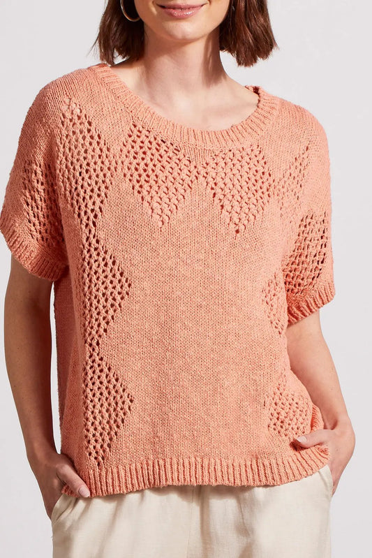 Woman wearing a stylish coral Dolman Short Sleeve Crochet Sweater by Tribal with a layering patterned design.