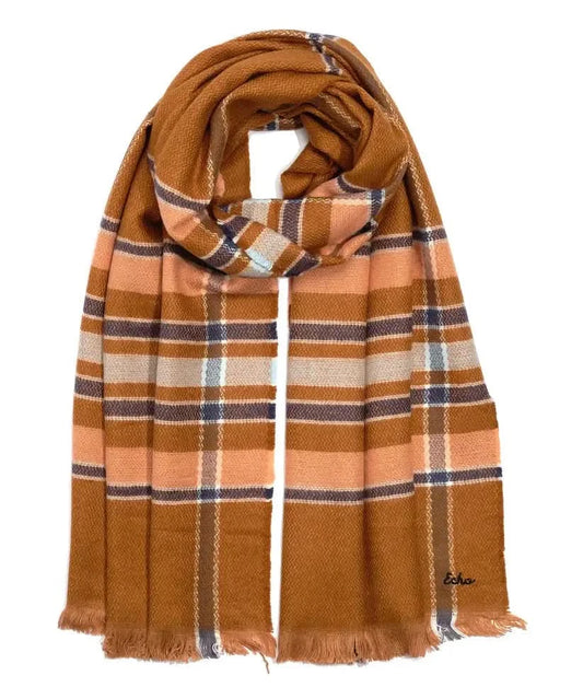 A woman wearing an Echo New York Campfire Plaid Scarf measuring 22" X 76".