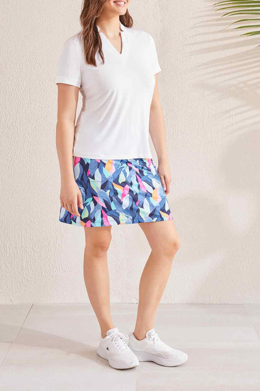 A woman wearing a comfortable fit Tribal blue and white polka dot skort.