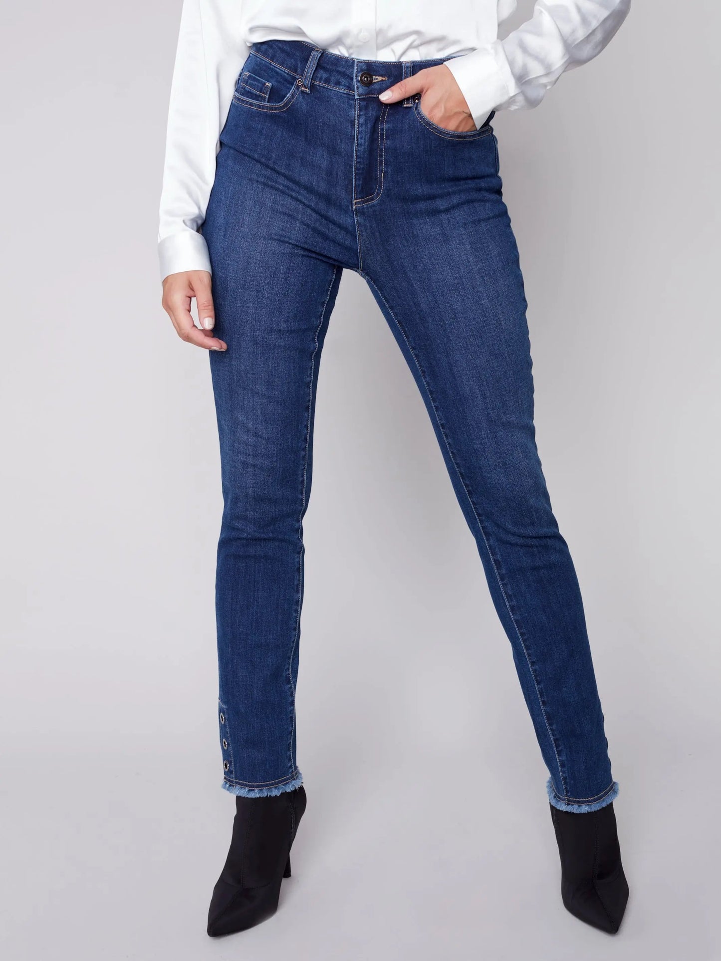 The model is wearing Charlie B white frayed bottom eyelet jeans.