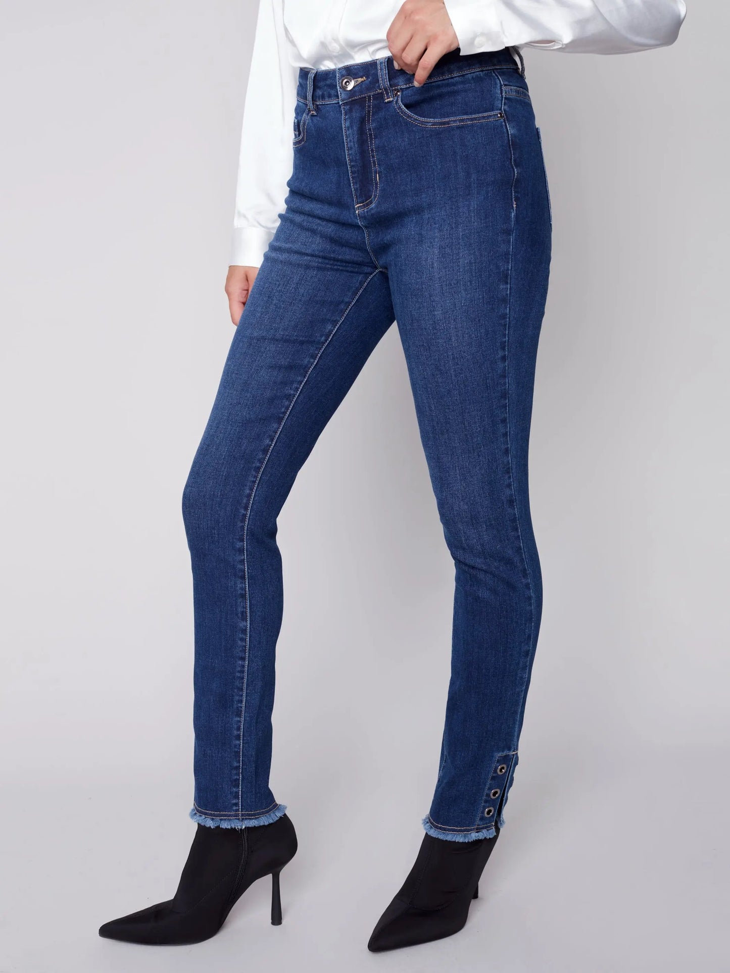 The model is wearing Charlie B white frayed bottom eyelet jeans.