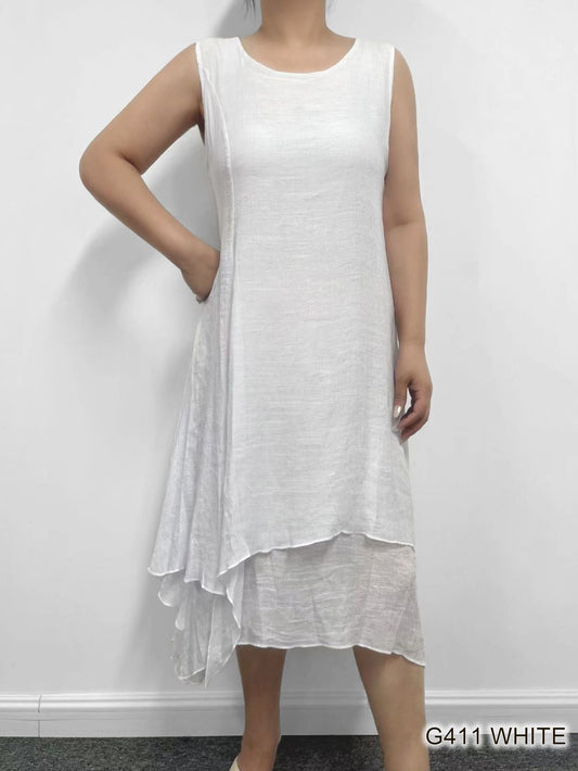A person modeling a white, sleeveless, asymmetrical Layered Round Neck dress from Fashion Cage against a plain background.