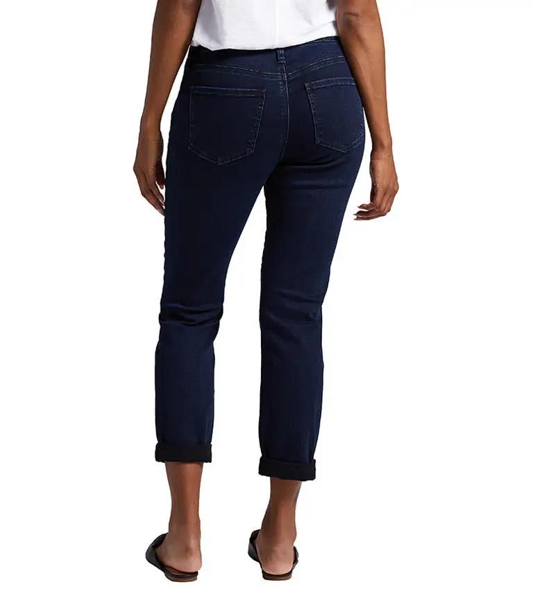 A woman is standing in Jag's Carter Girlfriend Jeans, which are sustainable denim jeans.