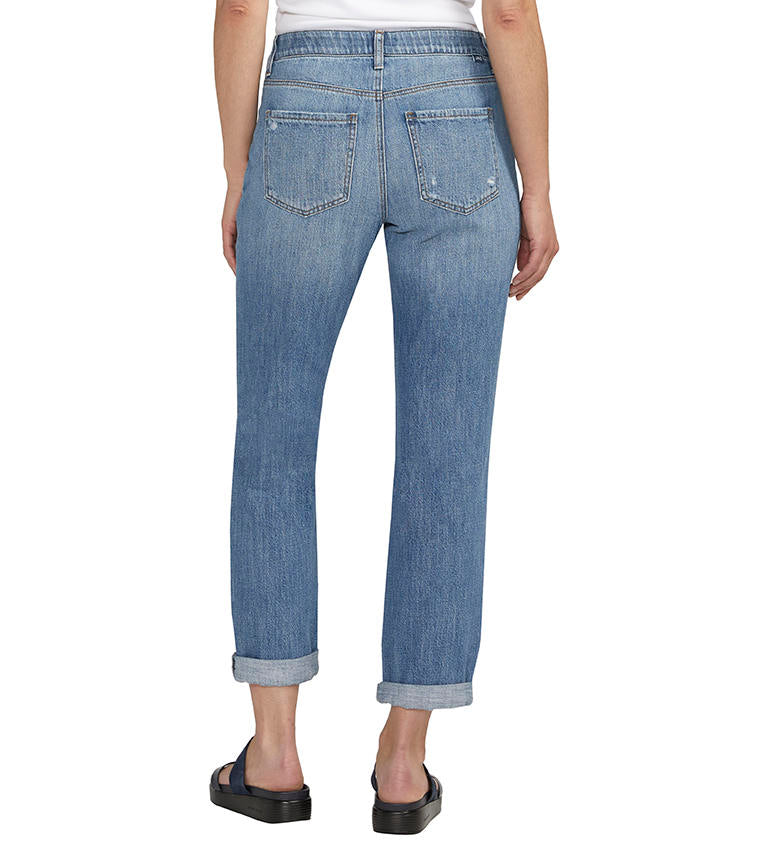 A woman is standing in Jag's Carter Girlfriend Jeans, which are sustainable denim jeans.