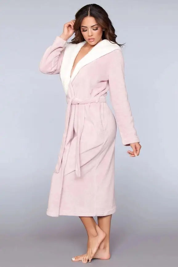 A woman wearing a BeWicked Janette Pink Robe with sherpa lining.