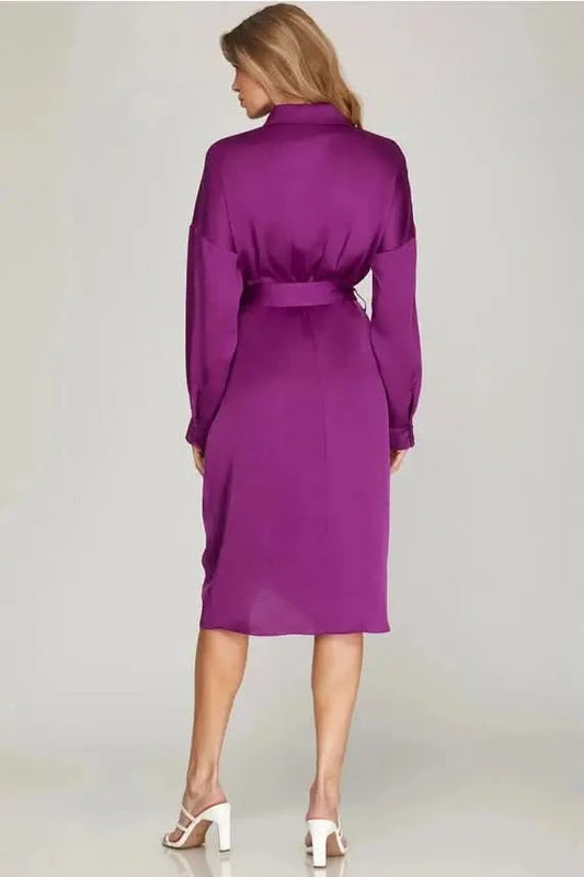 The model is wearing a Shirred Skirt Cuff Sleeve Drop Collar Midi Satin Dress from Vanilla Monkey.