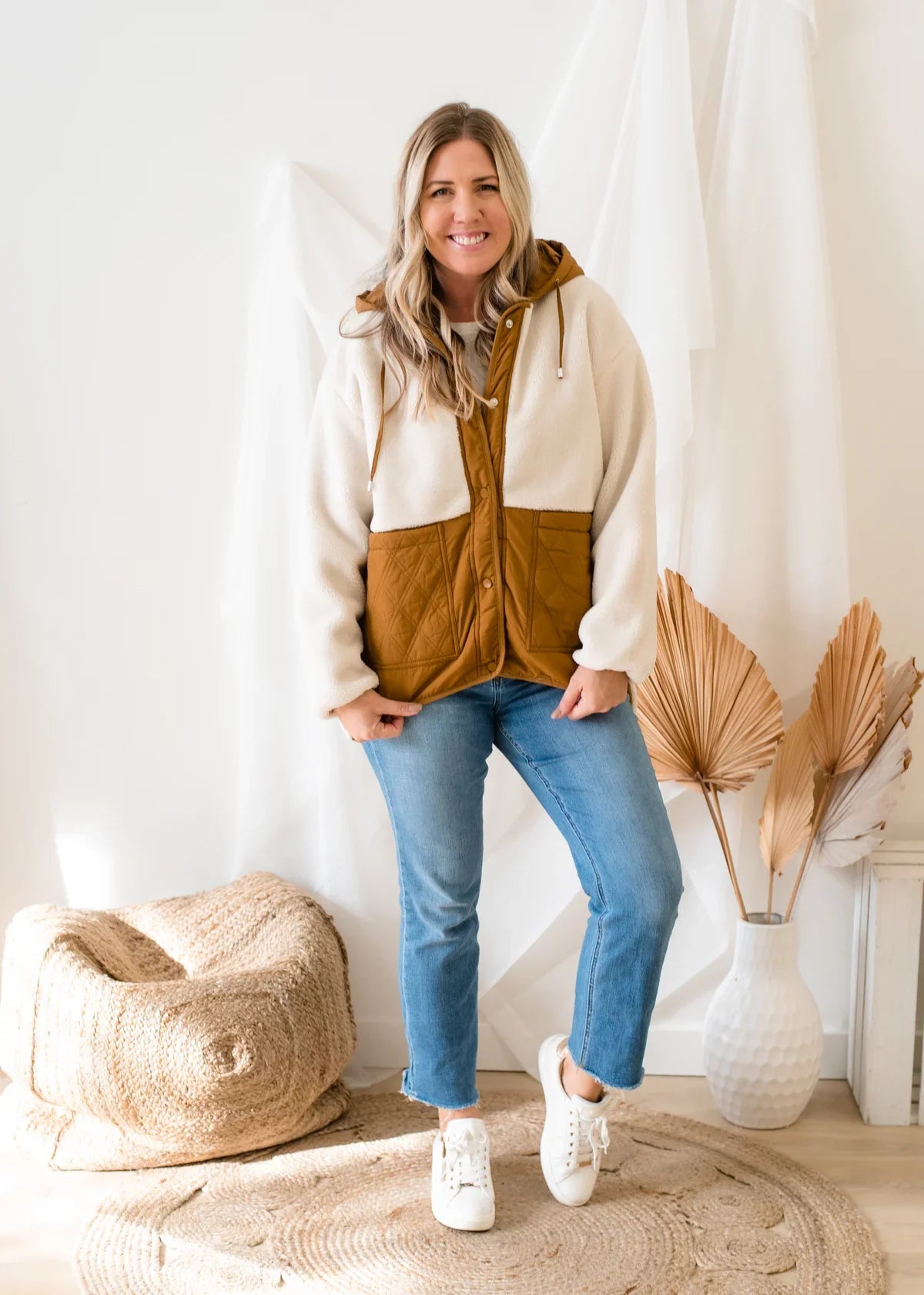 A woman wearing a cozy Molly Bracken Woven 2 Tone Sherpa Jacket for warmth and comfort.