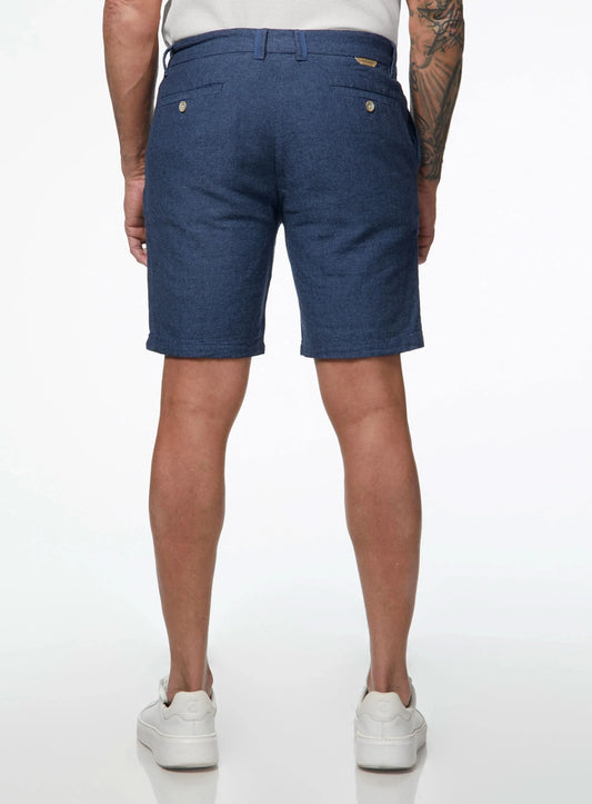 Close-up of a person wearing Point Zero Mens Chino Linen Flat Front Shorts in blue and a white textured shirt, with their right hand by their side—showcasing an effortless summer look in breathable fabric.