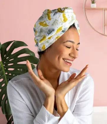 A package of Lemon Lavender Microfiber Turbo Towels with Button Closure | Plot Twist, featuring an image of a woman's face.