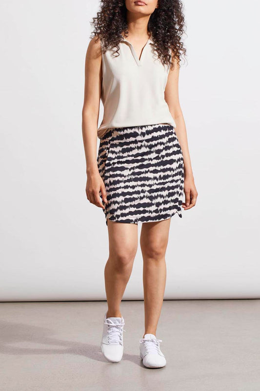Woman in a sleeveless top and a Tribal Pull On Skort with Rounded Hem standing against a neutral background.