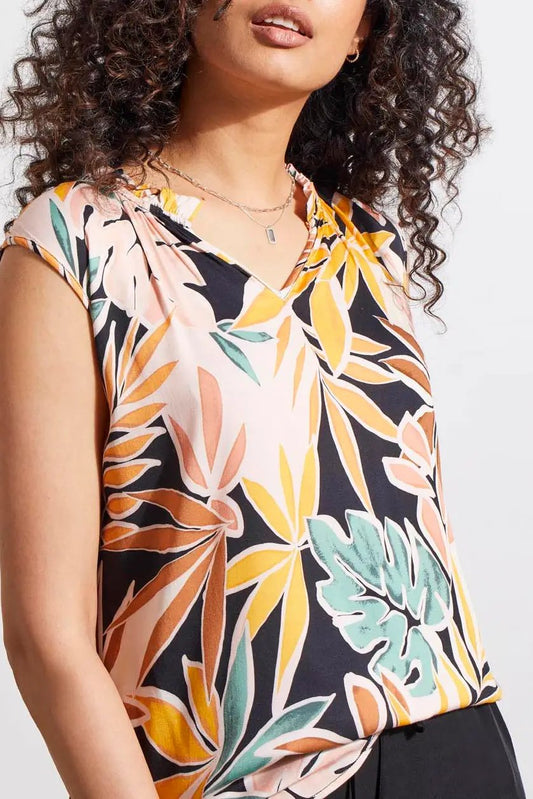 Woman wearing a stylish Tribal floral print blouse with a ruffle neck, with a close-up view focused on the top half.