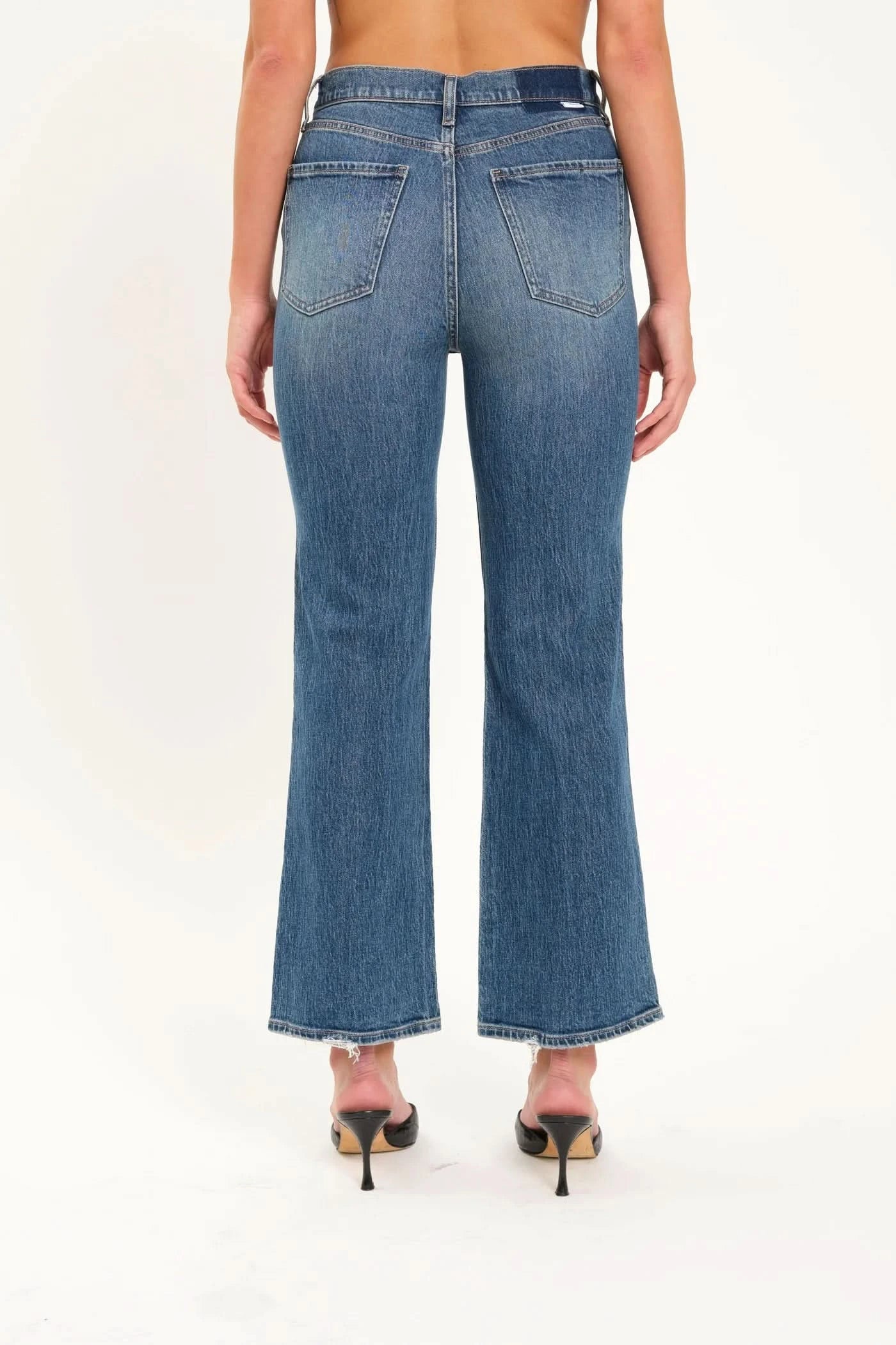 Person wearing Daze's Soho High Rise jeans and black heels, standing against a plain white background.