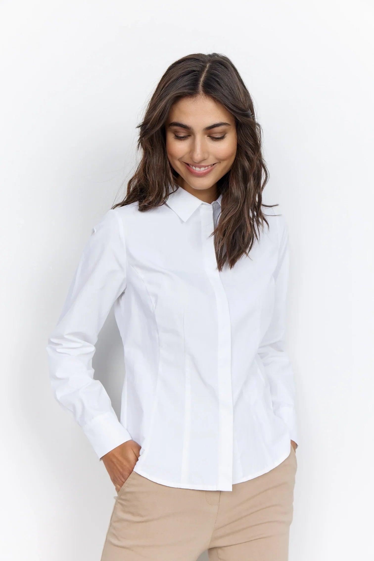 A woman wearing a Soya Concepts Classic White Button Up Shirt.