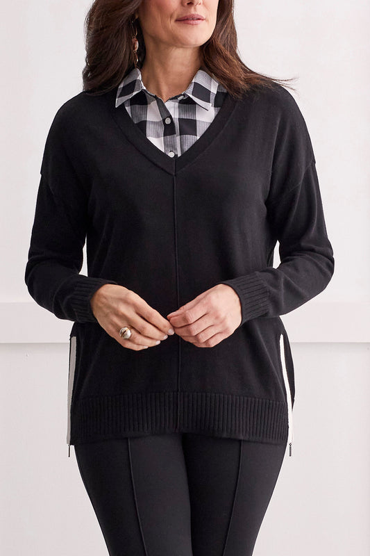 A woman wearing a cozy black Tribal V Neck Sweater with Side Zip.