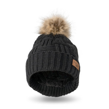 A woman wearing a Britt's Knits Classic Pom Hat in cold weather.