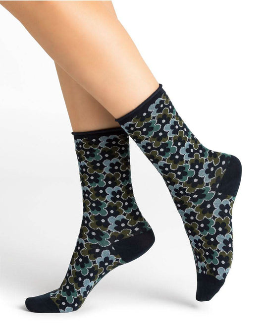 The woman's legs showcase her Bleuforet 6436 Bright Floral Velvety Socks Ink, radiating both softness and comfort.