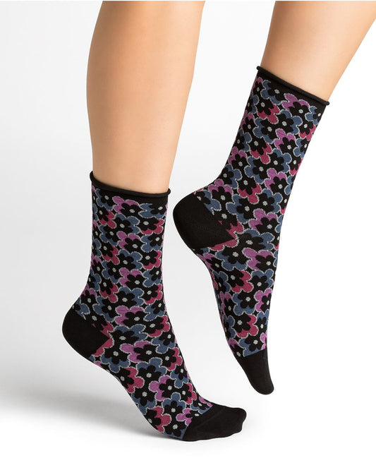 The woman's legs showcase her Bleuforet 6436 Bright Floral Velvety Socks Ink, radiating both softness and comfort.
