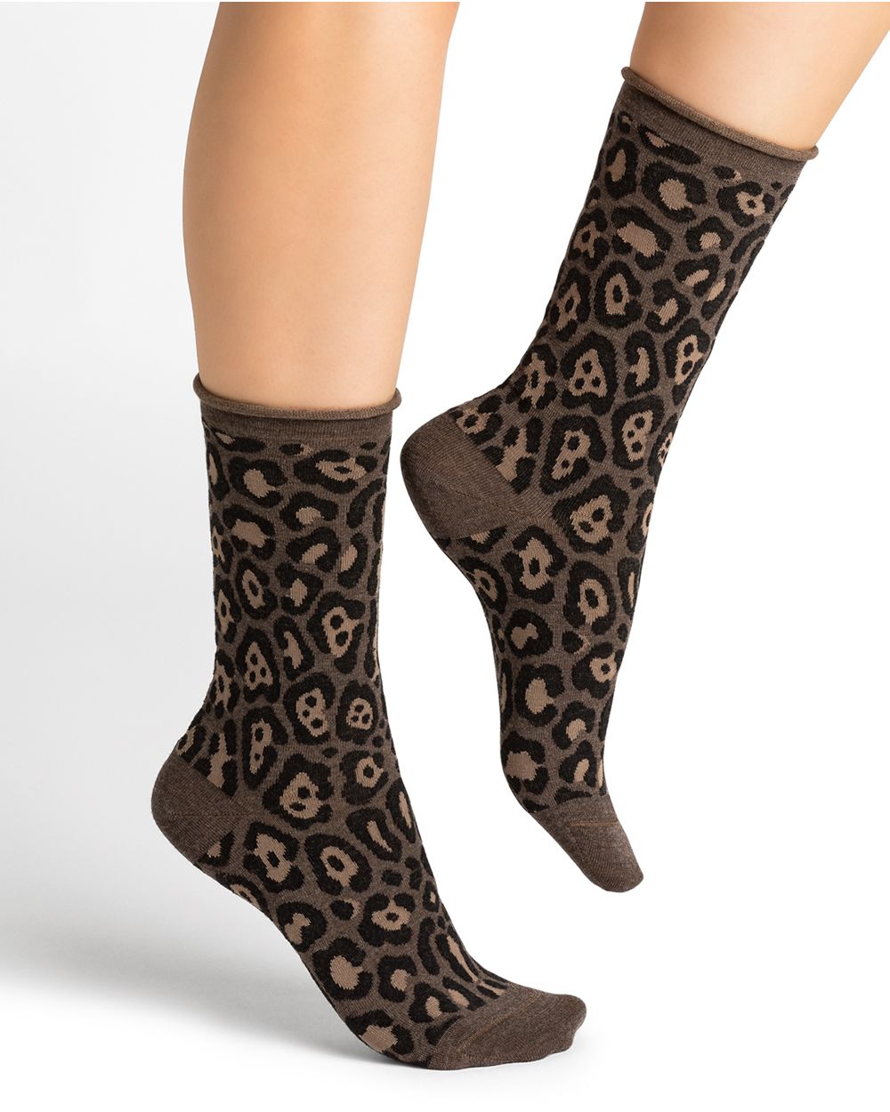 A woman's legs with Bleuforet black and grey leopard print merino wool socks.