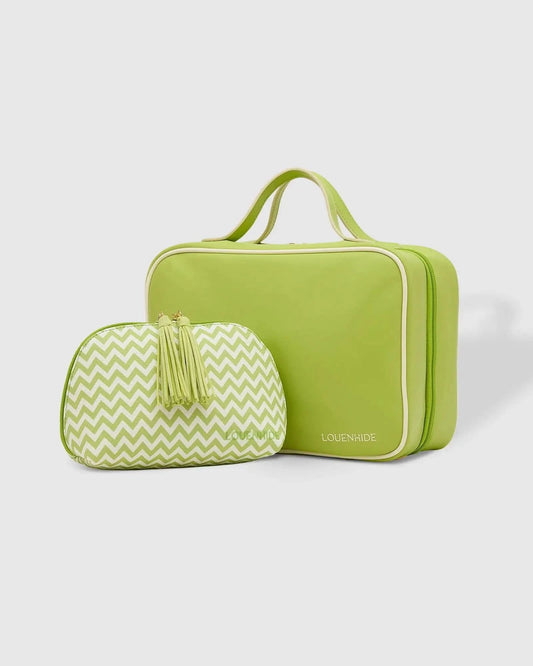 A Louenhide Baby Emma & Audrey Cosmetic Set in green, featuring a front zipper pocket with a partially visible "TO DO" list inside, surrounded by a comb, travel-sized bottle, and white flowers on a tiled surface.