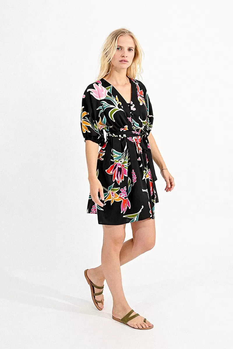 Woman wearing a Molly Bracken belted mini shirt dress with a floral print, ideal for a summer wardrobe.