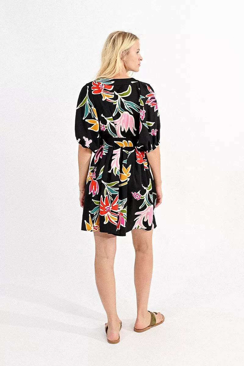 Woman wearing a Molly Bracken belted mini shirt dress with a floral print, ideal for a summer wardrobe.