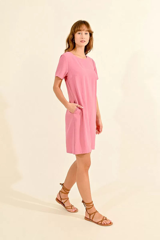 Woman in a pink Molly Bracken Mini Straight Dress with Pockets and strappy sandals posing against a neutral background.