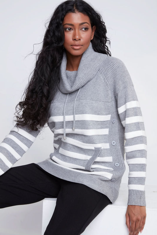 A woman models the CoCo Y Club Knitted Sweater, showcasing gray and white stripes, a cowl neck, front pockets, and side button details against a plain light background.