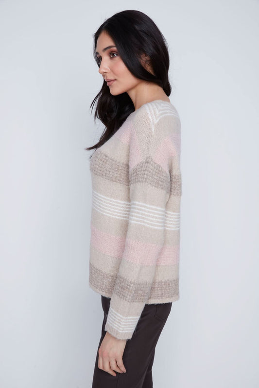 A woman stands against a plain background wearing the CoCo Y Club Stripped Knitted Sweater, paired with dark pants and black ankle boots.