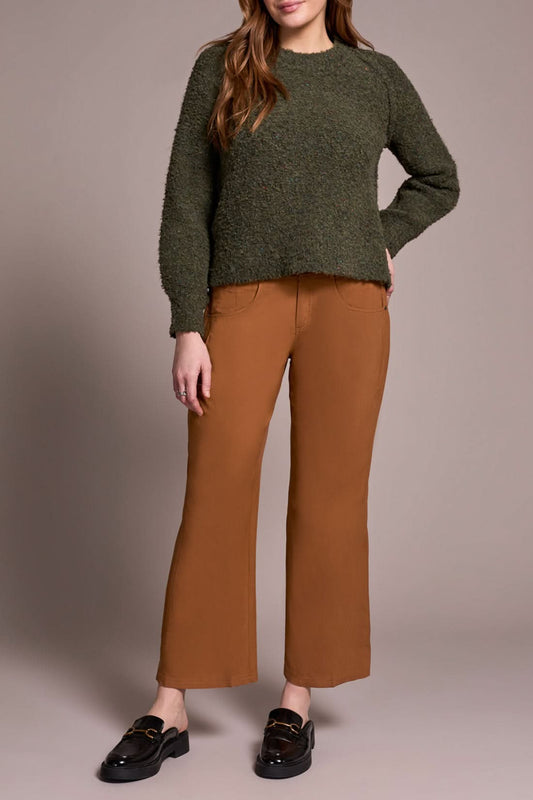 A woman wears brown pants and a Tribal Knit Crewneck Sweater Ivy.