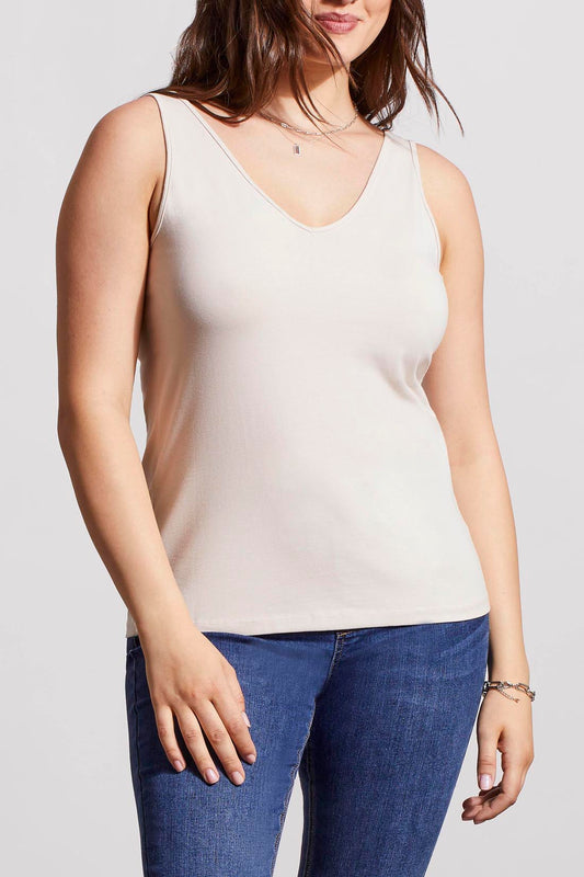 A woman in a cream Tribal Two Way Camisole and blue jeans, standing with one hand partially in her pocket.