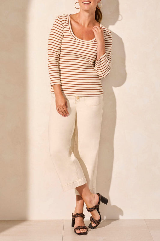 A person wearing a beige and brown 3/4 Sleeve Crew Neck Top by Tribal and cream pants stands against a light background.