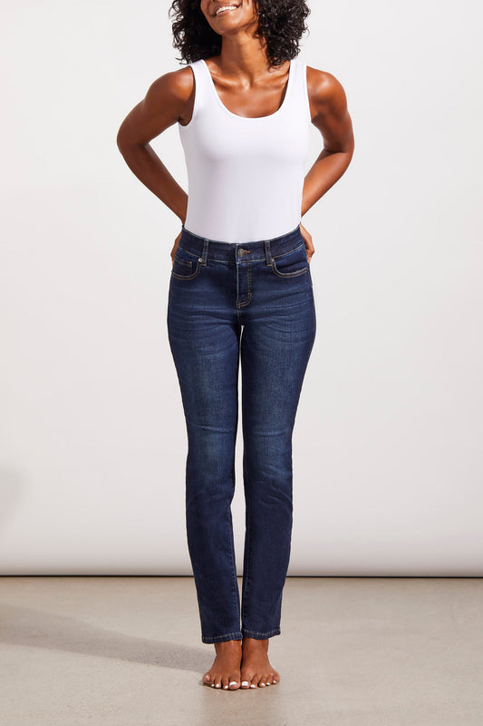 A woman in Tribal Sophia Jeans standing in front of a white wall.