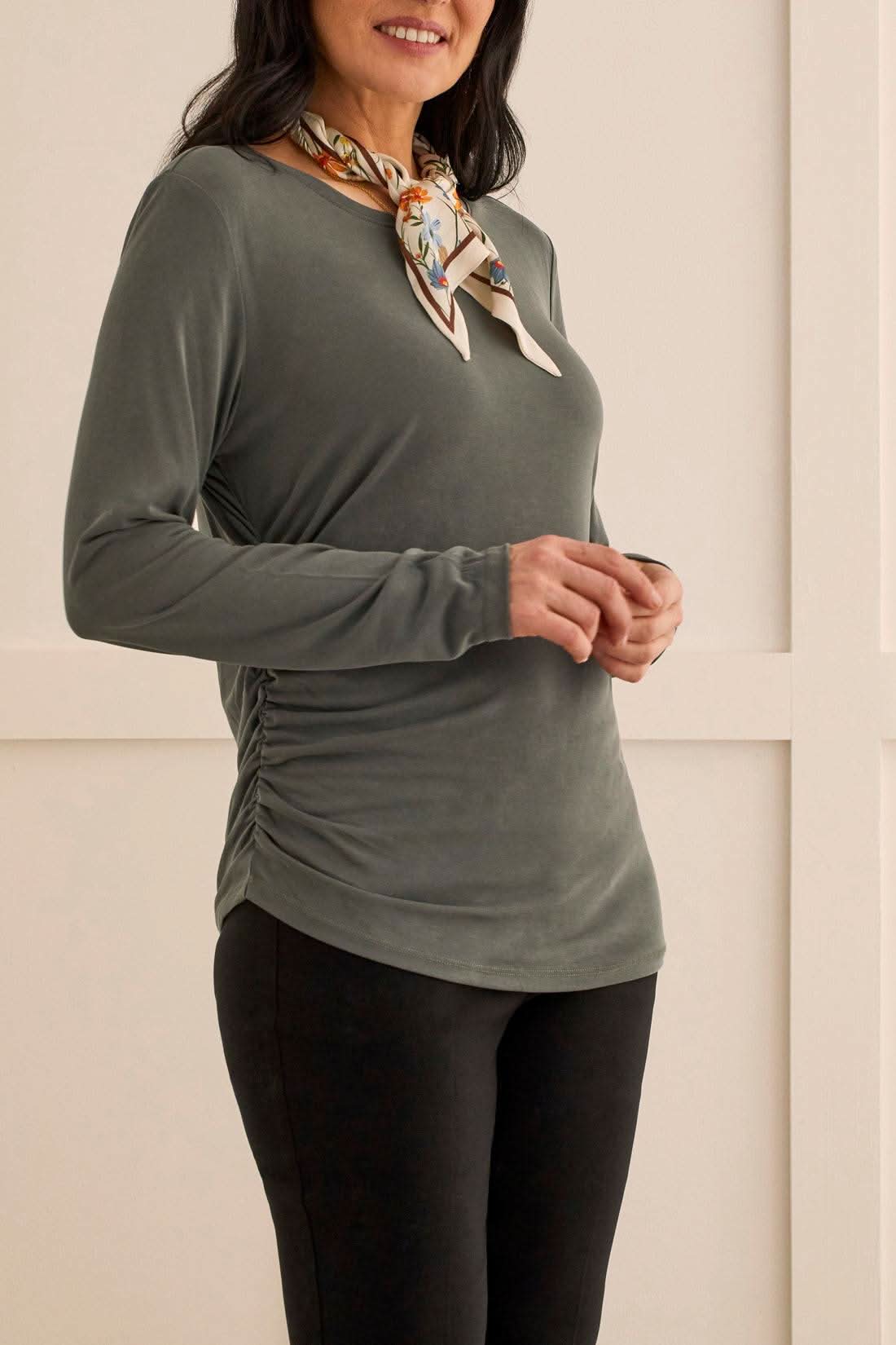 The model is wearing a stylish Tribal Crew Neck Top with Side Ruching.