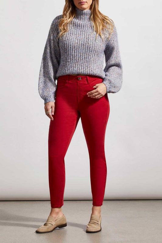A woman wearing red Tribal Audrey Icon Pull On skinny jeans and a blue sweater with a flattering fit.