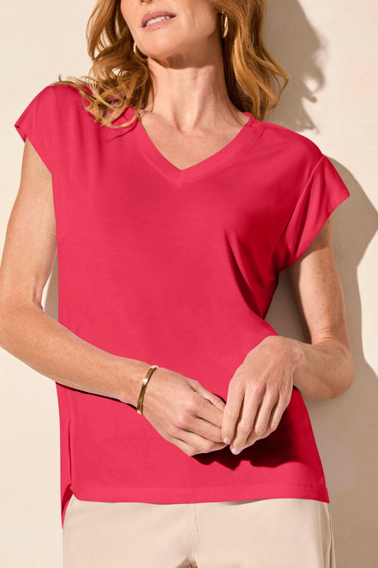 A person in a Tribal CAP SLEEVE V NECK TOP, beige wide-leg pants, and platform sandals stands against a light background, exuding timeless elegance.