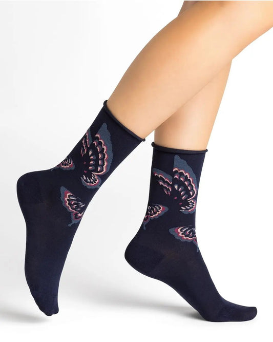 A woman's legs adorned with soft and comfortable Bleuforet 6435 Velvety Butterfly Socks Black featuring birds.