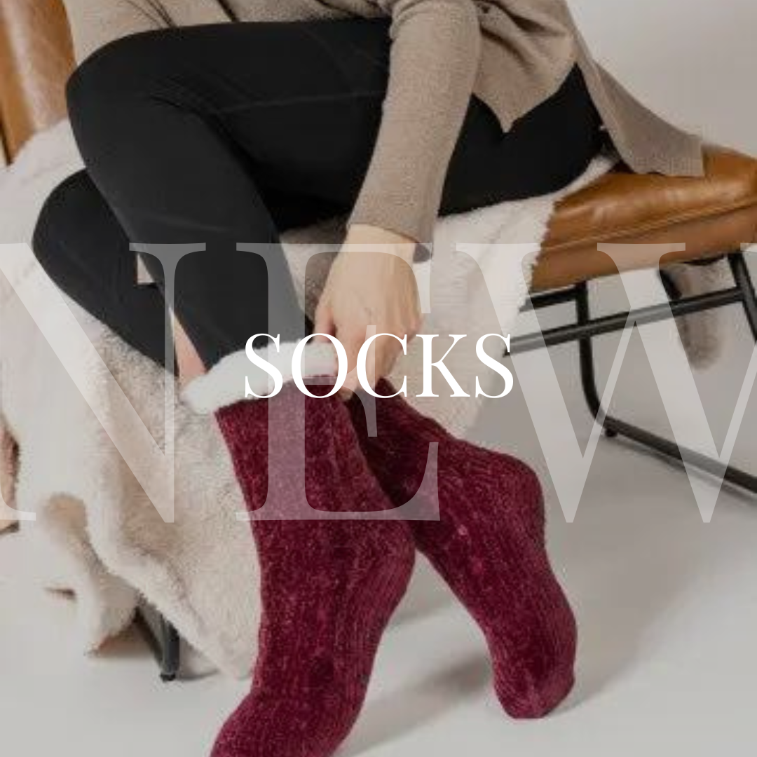 A woman sitting on a chair wearing burgundy socks.