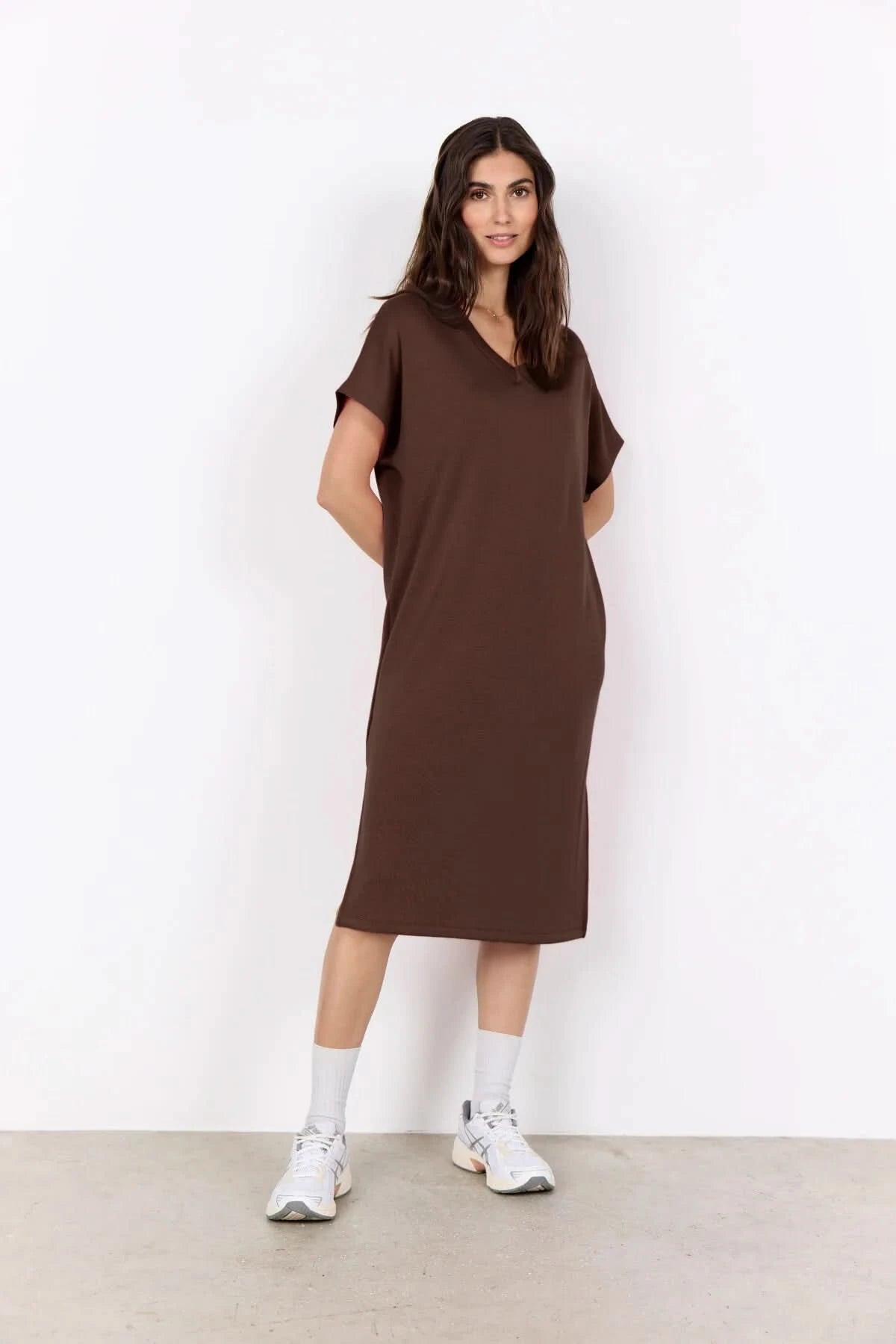 A woman stands against a white background wearing the Soya Concepts Banu V Neck Dress—a loose-fitting, knee-length pink dress with short sleeves.