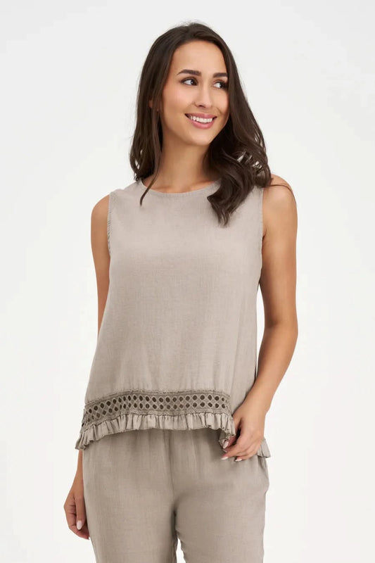 A woman wears the M Made In Italy Boho Top, a sleeveless beige piece with lace trim and ruffle hem, paired with matching pants, standing against a white background.