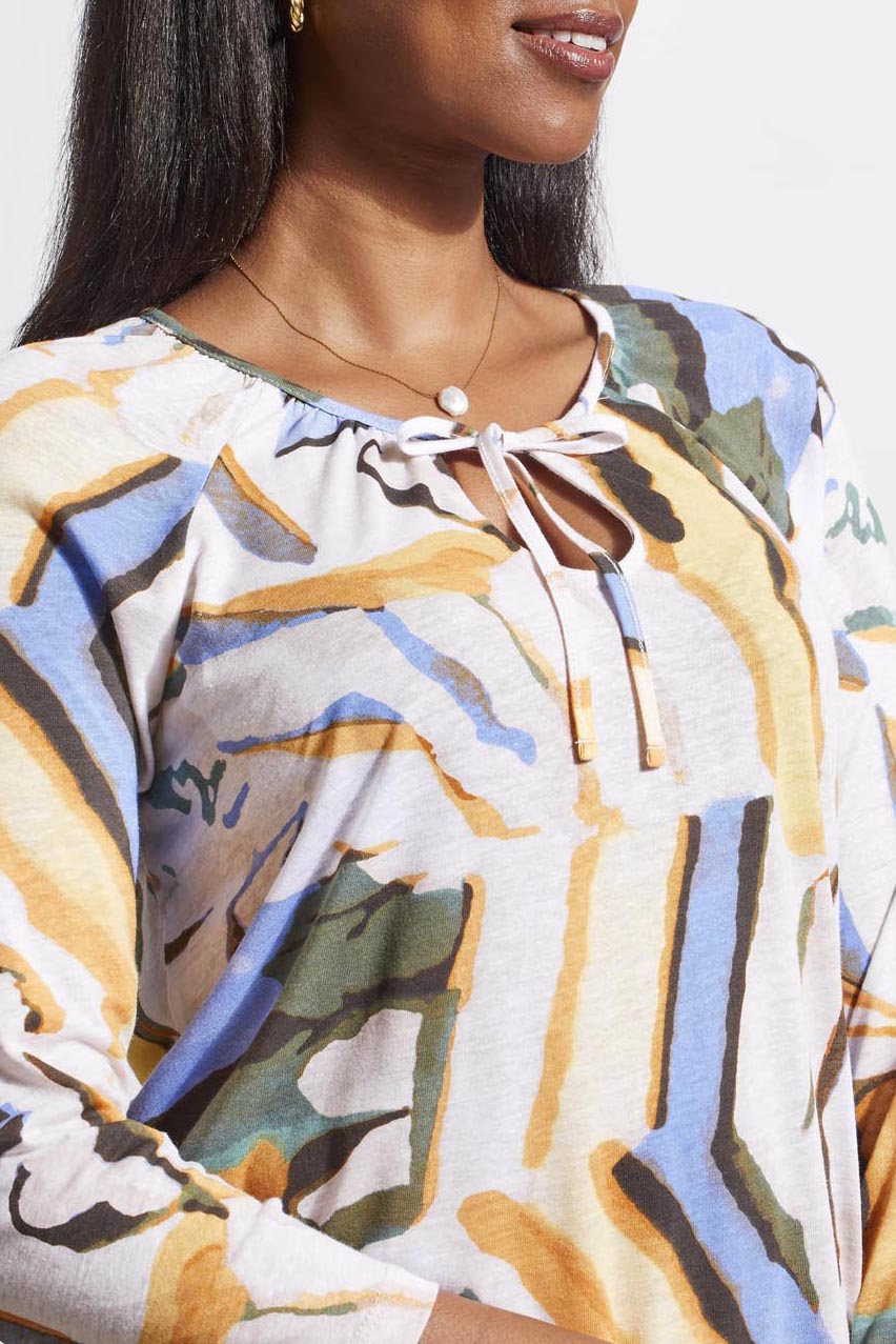Woman wearing a colorful abstract-patterned Tribal 3/4 Sleeve Peasant Top with Ties, exuding boho chic style.