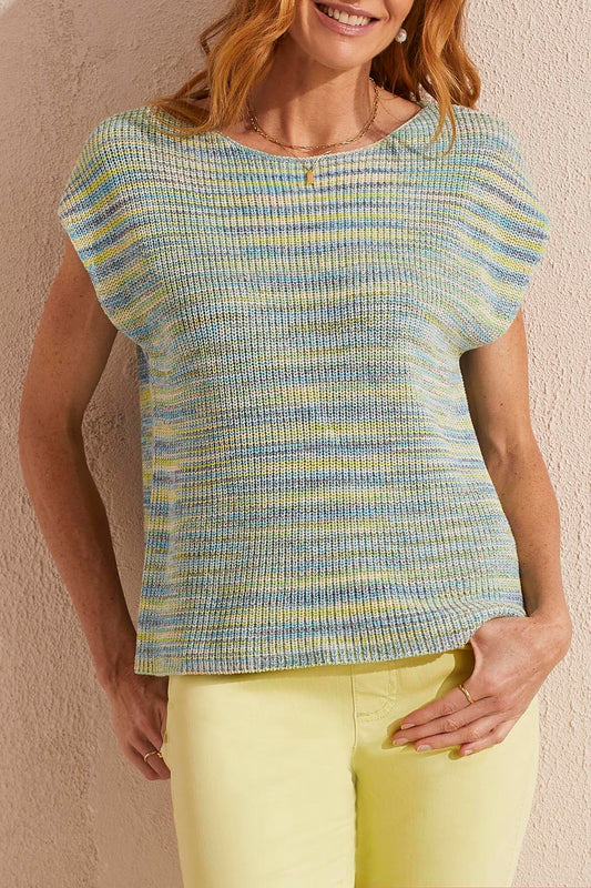 Woman posing in a chic, pastel-colored Tribal cap sleeve sweater and comfortable yellow pants.