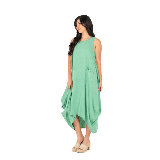 A person exudes effortless chic wearing the M Made In Italy Sleeveless Jade Dress with pockets, set against a plain white backdrop.
