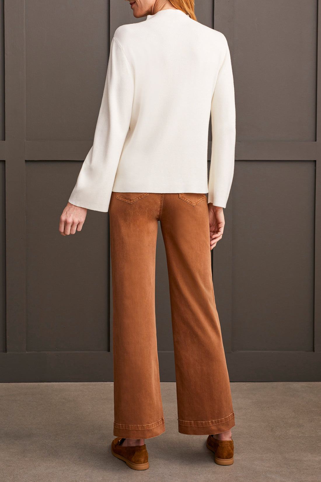 A woman with shoulder-length hair wearing a cozy and stylish yellow Funnel Neck Sweater from Tribal crosses her arms.