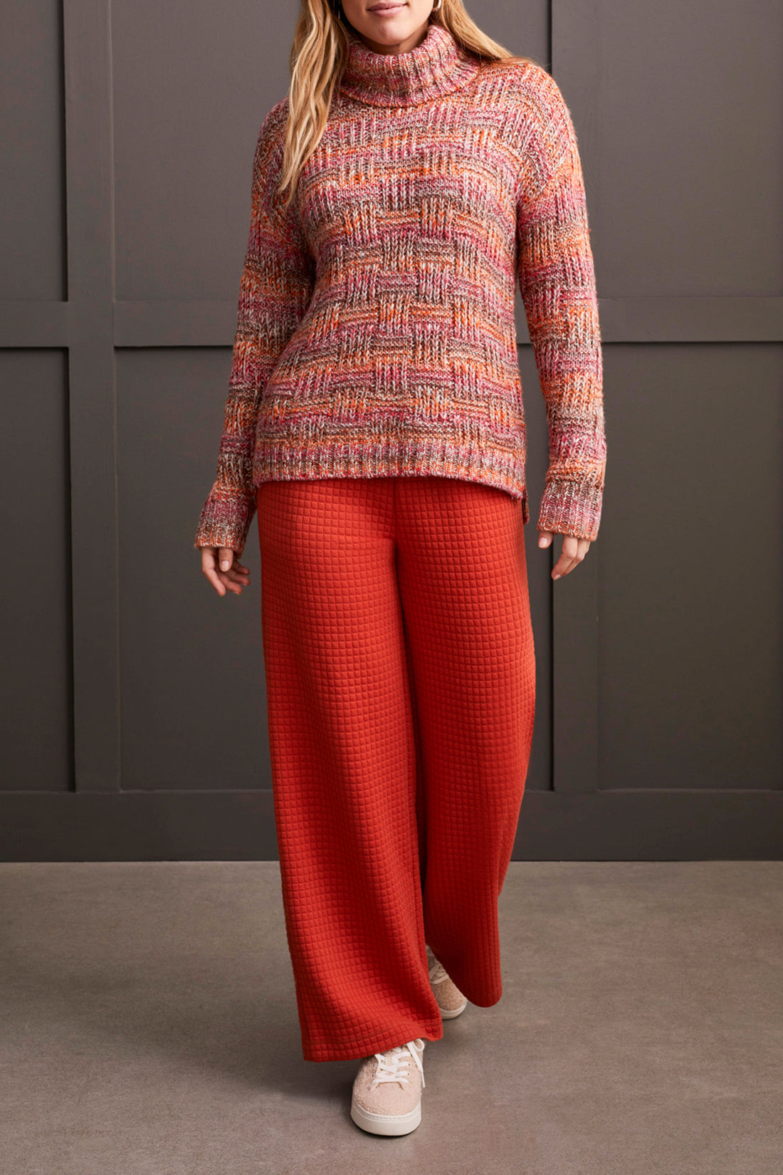 A person wearing a multicolored, fashionable long sleeve cowl neck sweater by Tribal with a textured pattern.